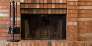 Brick fireplace with tools. Chimney Damper Repair by Masonry Waterproofing, and Drainage Masters in Portland OR and Vancouver WA