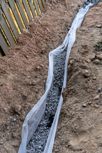 Gravel in French Drain. Masonry Waterproofing and Drainage Masters in Portland OR and Vancouver WA explain what a French drain is.