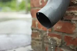 downspout depositing water too close to brick and foundation of home in portland OR